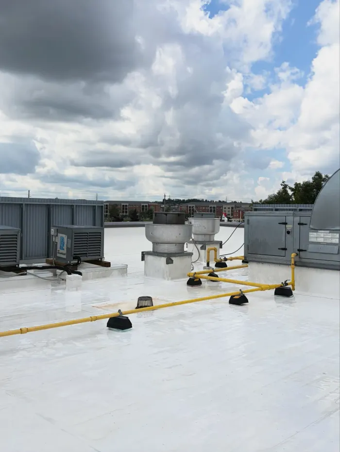 The same rooftop around the exhaust fans clean and white after cleaning